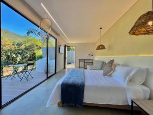a bedroom with a large bed and a balcony at Trip Monkey del Río in San Gil