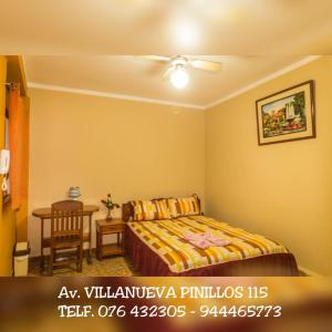 a bedroom with a bed and a table in it at Hospedaje La Terraza in Jaén