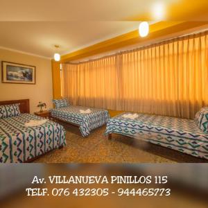 a hotel room with two beds and curtains at Hospedaje La Terraza in Jaén +4 photos