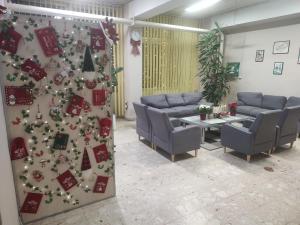 a waiting room with a christmas tree on the wall at Hostel Arena in Zagreb