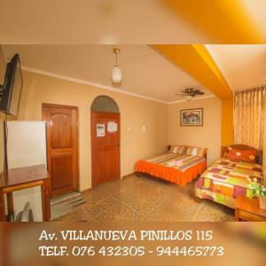 a hotel room with two beds and a tv at Hospedaje La Terraza in Jaén