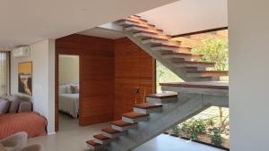 a staircase in a house with a bedroom at Casa Céu do Siriú in Garopaba +21 photos
