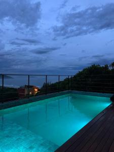 a swimming pool at night on a roof at Casa Céu do Siriú in Garopaba