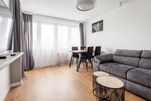 een woonkamer met een bank en een tafel bij Warsaw View Residance in Warschau