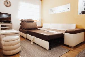 a room with a couch and a table and a chair at Ice Queen Vlasic in Šišava