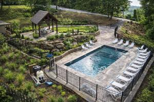 an overhead view of a pool with chairs and a gazebo at Star Dancer Cabin in Gatlinburg