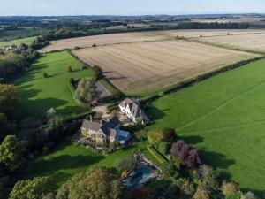een luchtfoto van een groot huis in een veld bij Cotswold Stable Cottage in Bibury