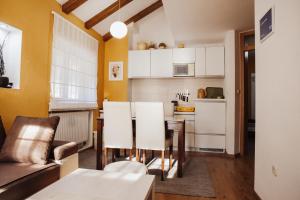 a kitchen and a living room with a table and chairs at Ice Queen Vlasic in Šišava