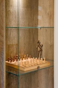 a chess board on a shelf in a room at Apartment MATEJA in Tivat