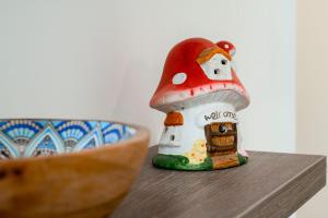 a small figurine of a mushroom house next to a bowl at Apartment MATEJA in Tivat +52 photos