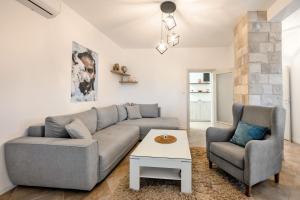 a living room with a couch and two chairs at Apartment MATEJA in Tivat