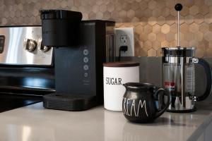 a counter with two coffee cups and a coffee maker at Broadway in Rockport