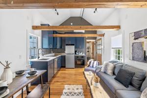 a kitchen and living room with blue cabinets at Broadway in Rockport