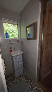 a bathroom with a sink and a window at Mombacho Lodge in Granada