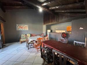 a dining room with a table and chairs at Casa com piscina in Tramandaí