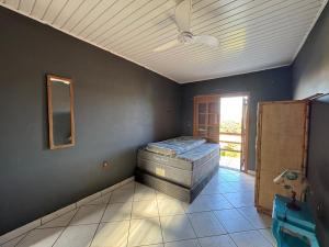 a room with a bed in the corner of a room at Casa com piscina in Tramandaí