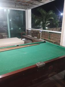 een pooltafel in een kamer met twee banken bij Litoral suítes in Araruama