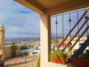 a balcony with a table and chairs and a view at Paradise House Apartment in Tamraght in Tamraght Ouzdar