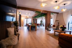 a living room with a table and a dining room at Imperial Home Chalet in Sibiu