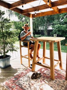 a man is sitting at a picnic table at Rainbow Lodge in Motueka