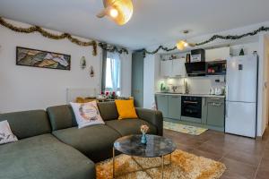 a living room with a couch and a table at Alpine Arve Get'Away in Cluses