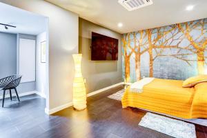 a bedroom with a bed and a painting on the wall at 'Little House on the Lot' Dryden Townhome: Pets OK in Dryden