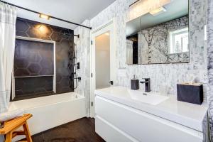 a bathroom with a sink and a mirror at 'Little House on the Lot' Dryden Townhome: Pets OK in Dryden +18 photos