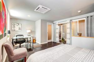 a bedroom with a bed and a chair at 'Little House on the Lot' Dryden Townhome: Pets OK in Dryden