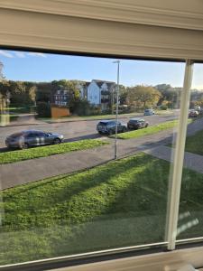 a view from a window of cars on a street at Work & Family Haven - Ashford in Ashford +34 photos