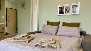 een slaapkamer met een bed met handdoeken erop bij Il Bumbunin di Collegno in Collegno