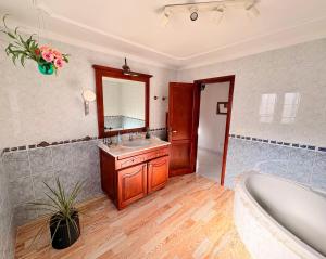 a bathroom with a tub and a sink and a mirror at myplace in Tiagua +8 photos