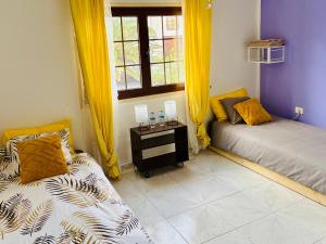 a room with two beds and a window at myplace in Tiagua