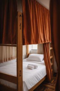two bunk beds in a room with a window at Shanti Hotel Pisac in Pisac