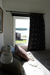 a bedroom with a bed and a large window at Aurora Jukkasjarvi in Jukkasjärvi