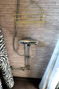 a shower with a hose attached to a wall at Aurora Jukkasjarvi in Jukkasjärvi +27 photos
