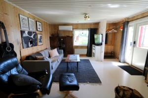 a living room with a couch and a table at Aurora Jukkasjarvi in Jukkasjärvi