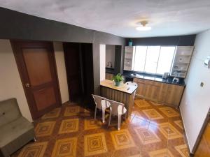 a small kitchen with a table and chairs in a room at Laguna Apartment in Huaraz