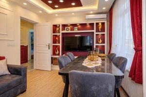 a dining room with a table and chairs and a television at Konak Grand Bella Sultanahmet in Istanbul