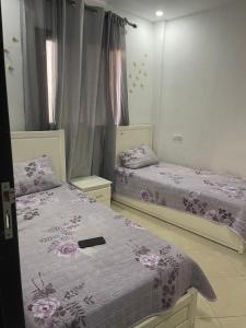 En eller flere senge i et værelse på Appartement