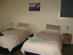 two beds sitting next to each other in a room at Delegate Galley Cabin in Delegate