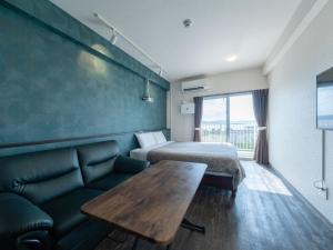 una camera d'albergo con letto, tavolo e divano di Hote Io Lite a Nago