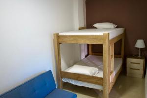 een kamer met 2 stapelbedden en een blauwe stoel bij Gairaka 3 in Gaira