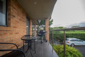 a balcony with a grill and a car parked at Spacious beachside family home in Rosebud +43 photos