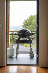 an open door to a balcony with a grill on it at Spacious beachside family home in Rosebud