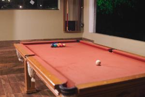 een rode pooltafel met een bal erop bij Pousada Horizonte da Canastra in São Roque de Minas