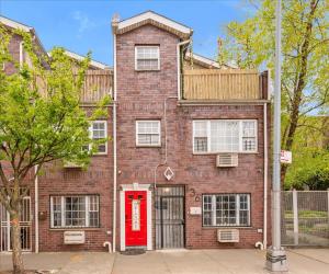 a red brick building with a red door at Brooklyn Double Decker in Brooklyn