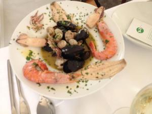 a plate of food with seafood on a table at Cavallino House Boat in Cavallino-Treporti