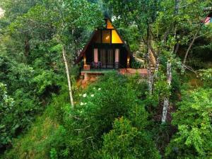 a small house in the middle of a forest at Water Side Residence in Adams Peak