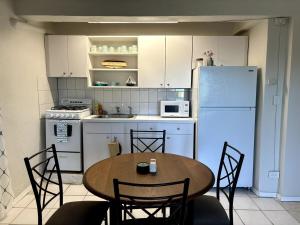 a kitchen with a table and a white refrigerator at Chill on Cassi Hill in Nazareth