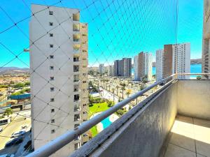 a view of a city from the balcony of a building at Oceanfront Vacation Pool WiFi Parking in Coquimbo